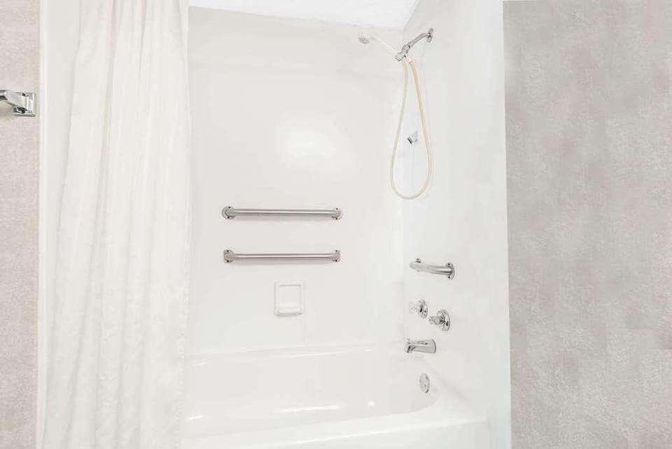 Bathroom with shower and tub. Basic toiletries and towels are provided