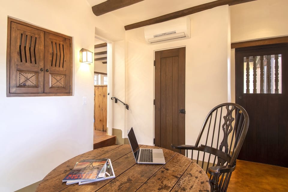 Guest suite sitting room or office with TV enclosure.