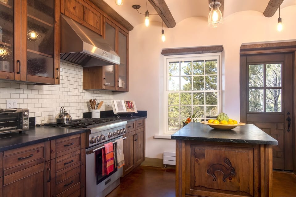 A gas stove with all small appliances:  coffee maker, toaster oven.