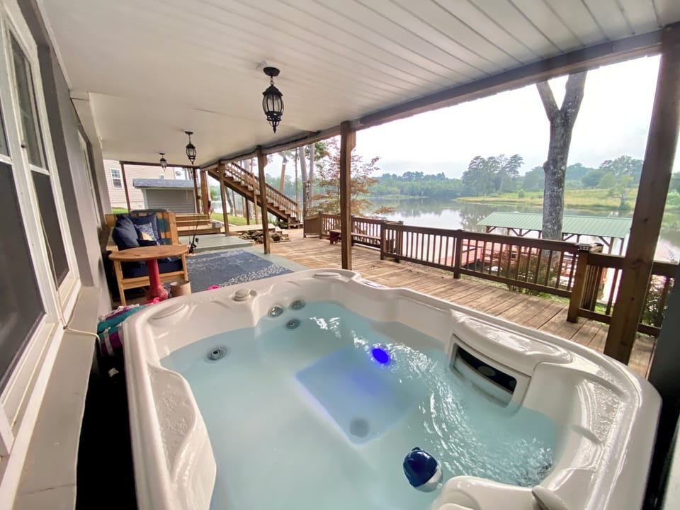 Covered terrace level with outdoor seating and hot tub 