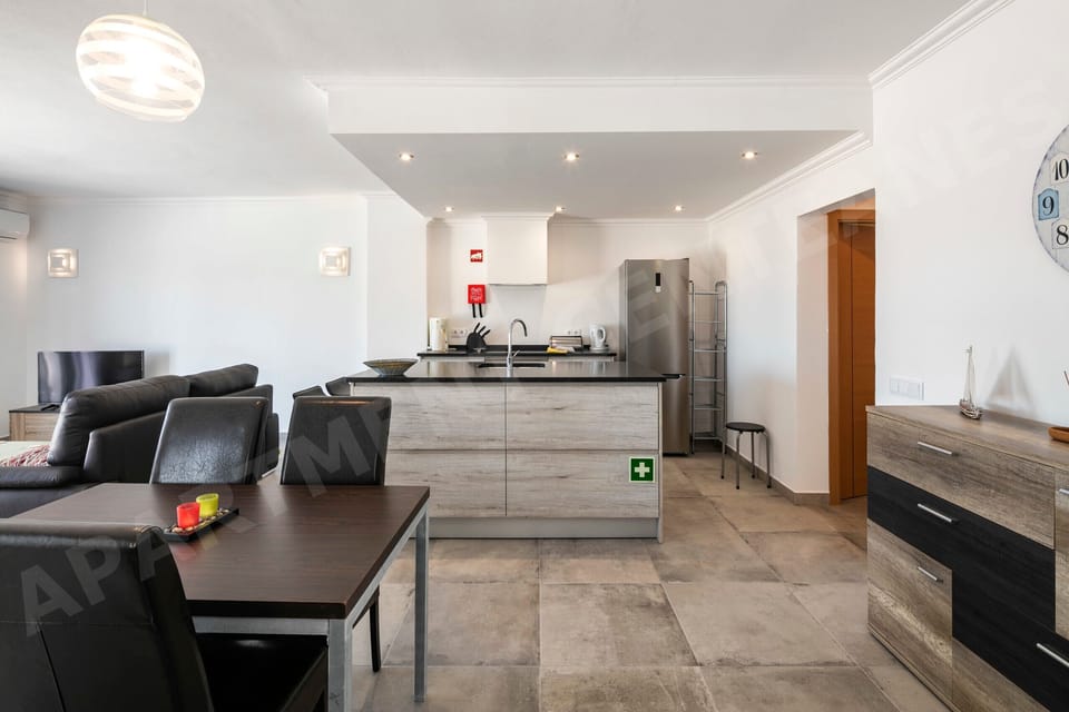 Contemporary kitchen with sleek cabinetry, breakfast bar seating, and high-end appliances. An ideal space for casual dining and cooking together.