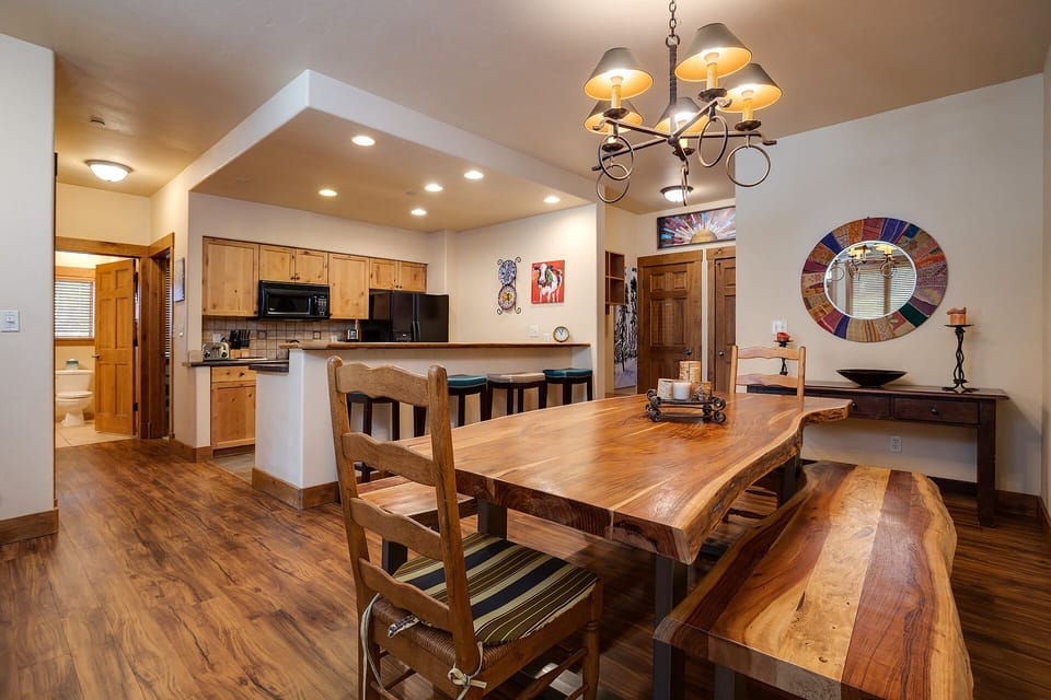 Gather around this stunning rustic dining table where your group can share memorable meals together in this beautifully appointed space.