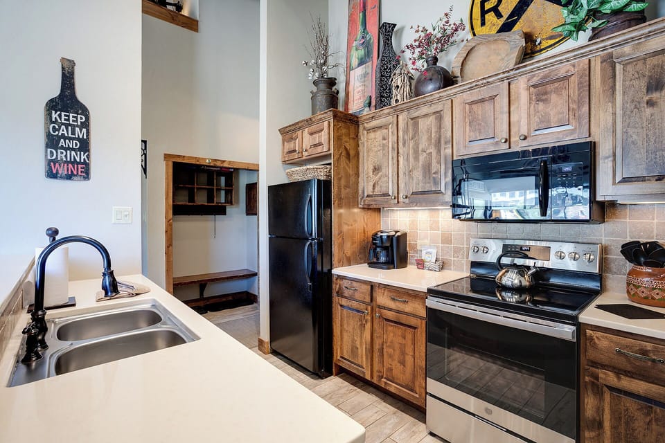 Your fully equipped kitchen features rustic wood cabinets, modern appliances, and everything needed for memorable home-cooked meals during your stay.