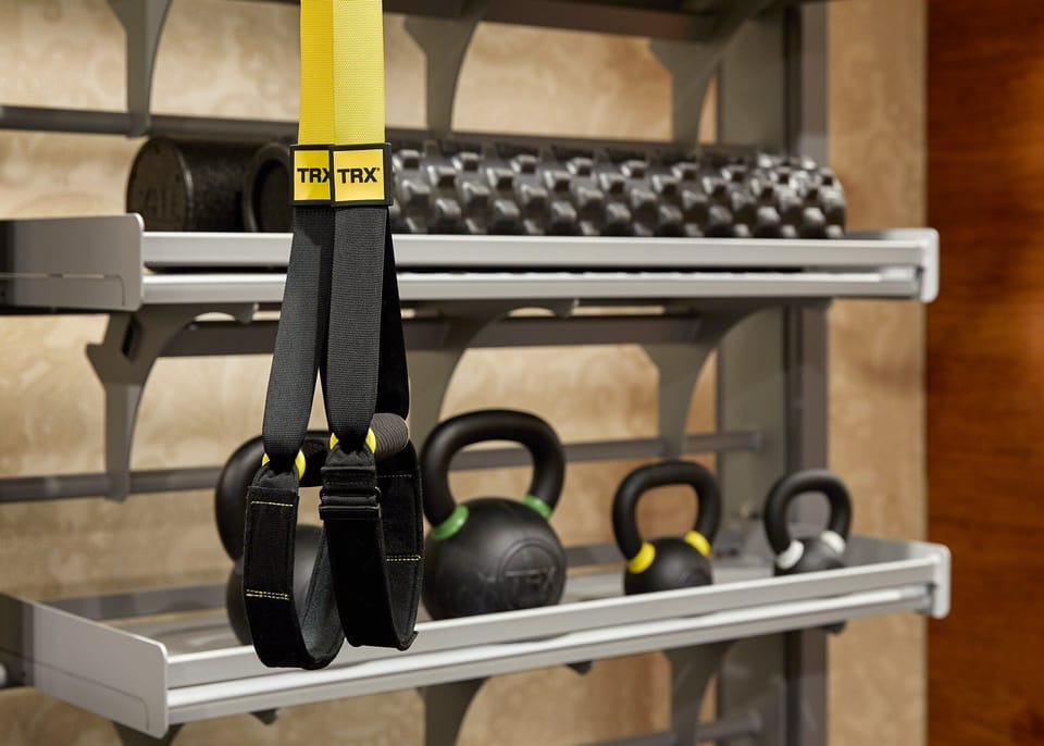Train effectively with TRX straps, kettlebells, and neatly racked weights.