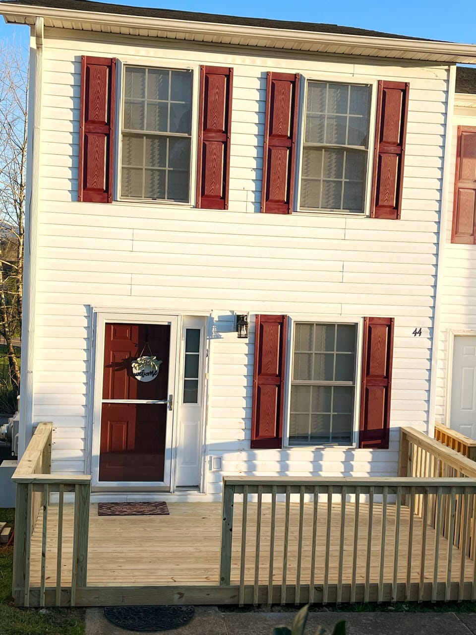 Bring attention to the 44 on the building and the 1 to the right of the door. 