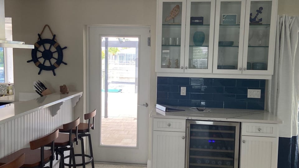Access to the lanai off the kitchen with wine fridge