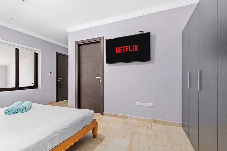 Experience the perfect blend of luxury and convenience in our rental property's bedroom with a closet and TV. Your cozy hideaway for relaxation and entertainment.