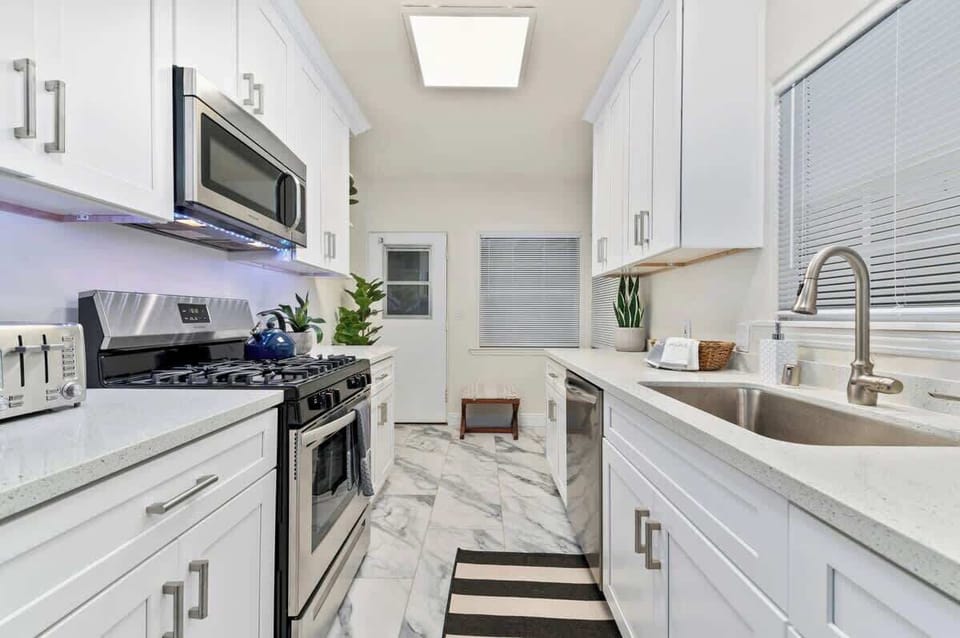 Kitchen and large refrigerator, providing ample storage for your culinary delights, ensuring your ingredients remain fresh and easily accessible throughout your stay...