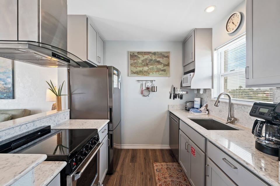 Your fully equipped galley kitchen features stainless appliances, marble countertops, and everything needed to prepare memorable meals during your stay.