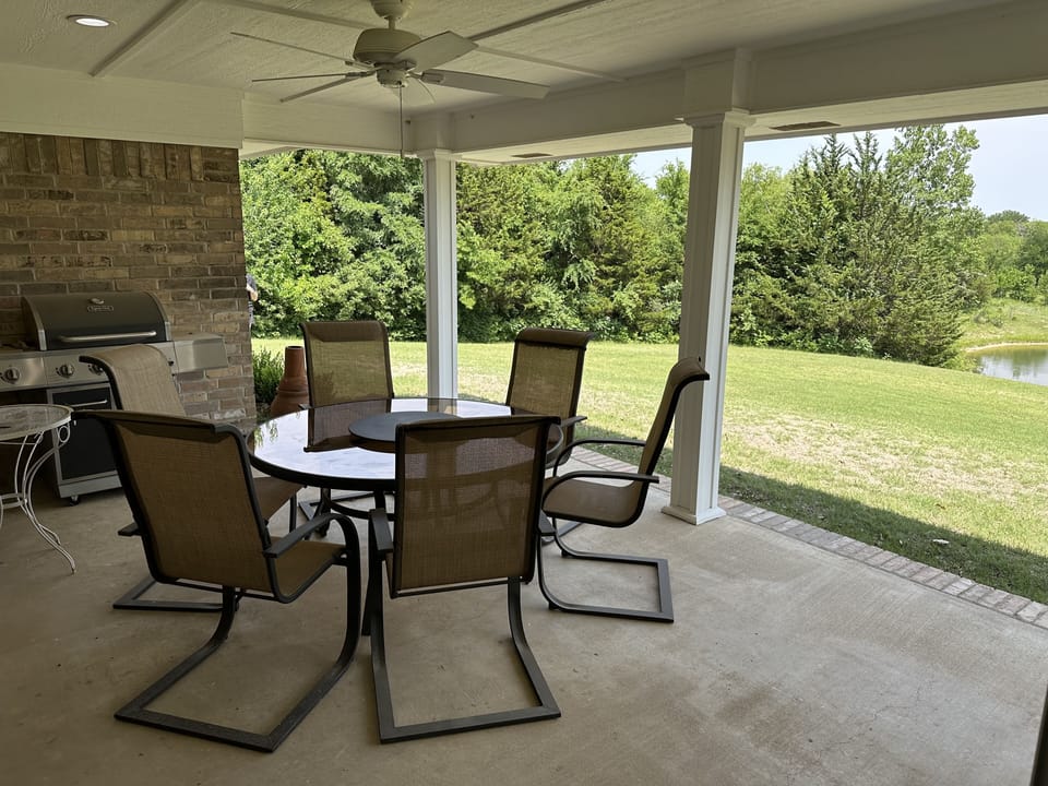 Covered Porch with Grill and outdoor dining table.