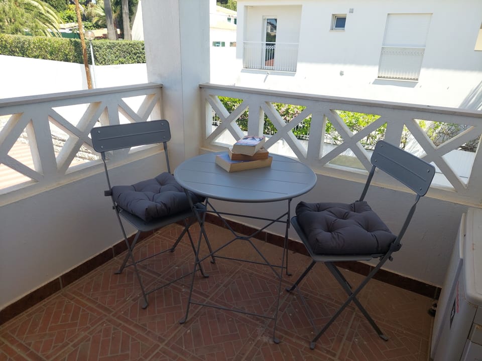 Pool and sun louge area, with outdoor dining table and chairs , and shower