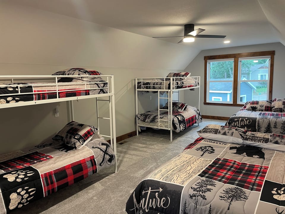Large bonus room with bunk beds and 2 full size beds.