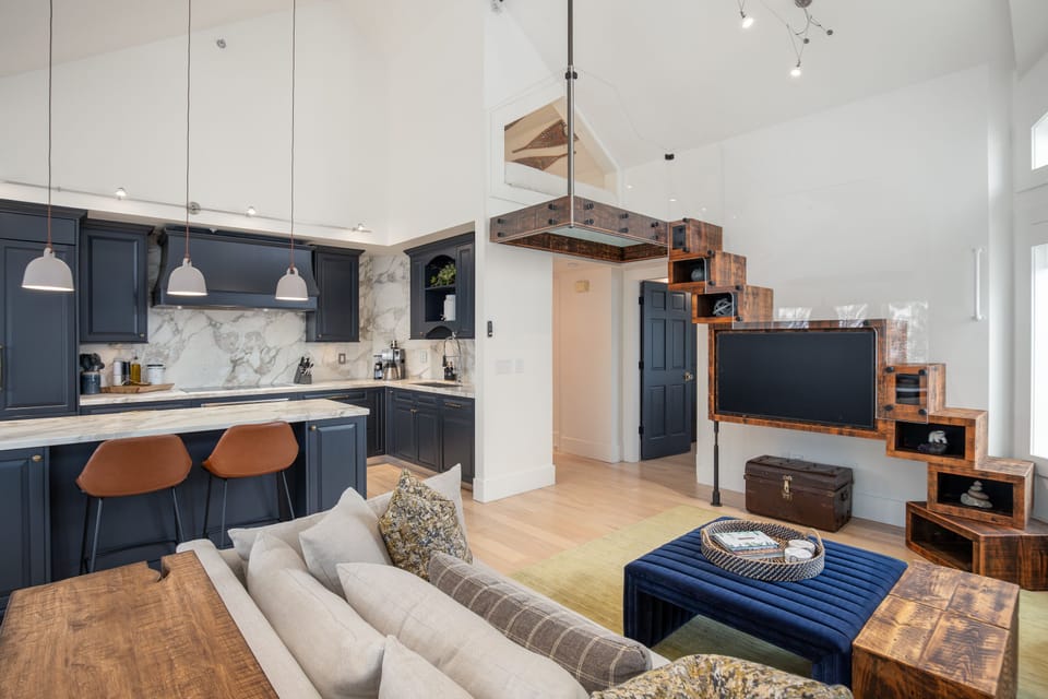 Kitchen and living area - modern, fully stocked kitchen, with large TV and additional loft sleeping space