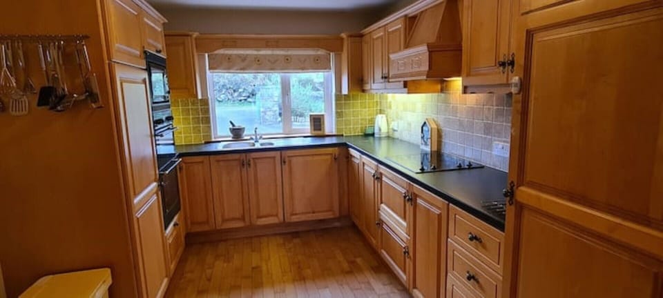 Kitchen with double over, integrated microwave, dishwasher, larder fridge & hob
