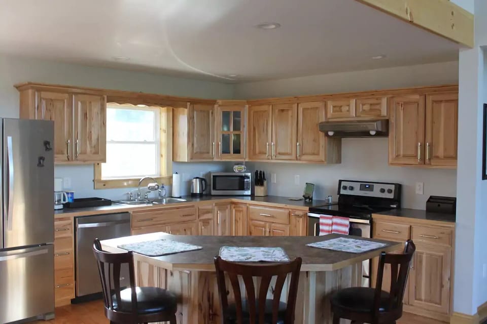 Kitchen with handmade Amish cabinets, modern appliances and breakfast bar
