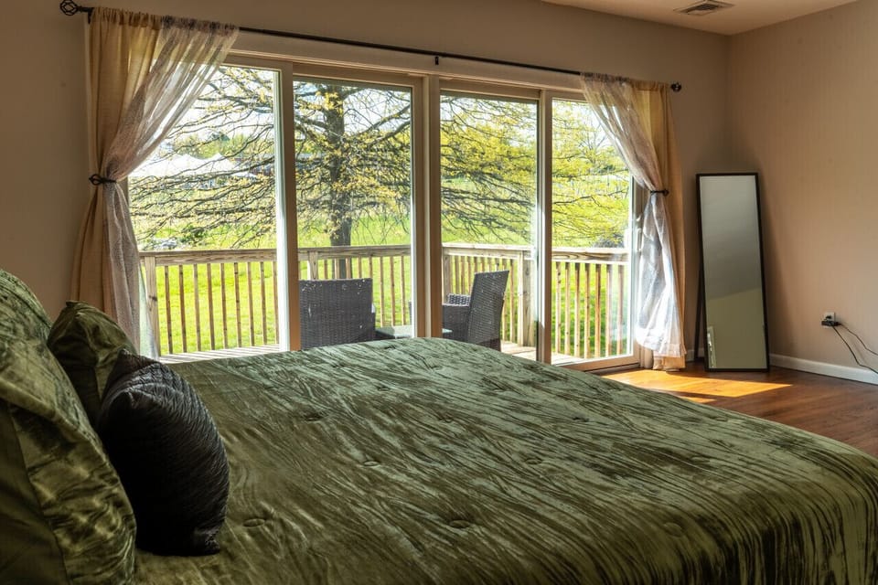Large, spacious master bedroom with a king bed, private bath, and private deck