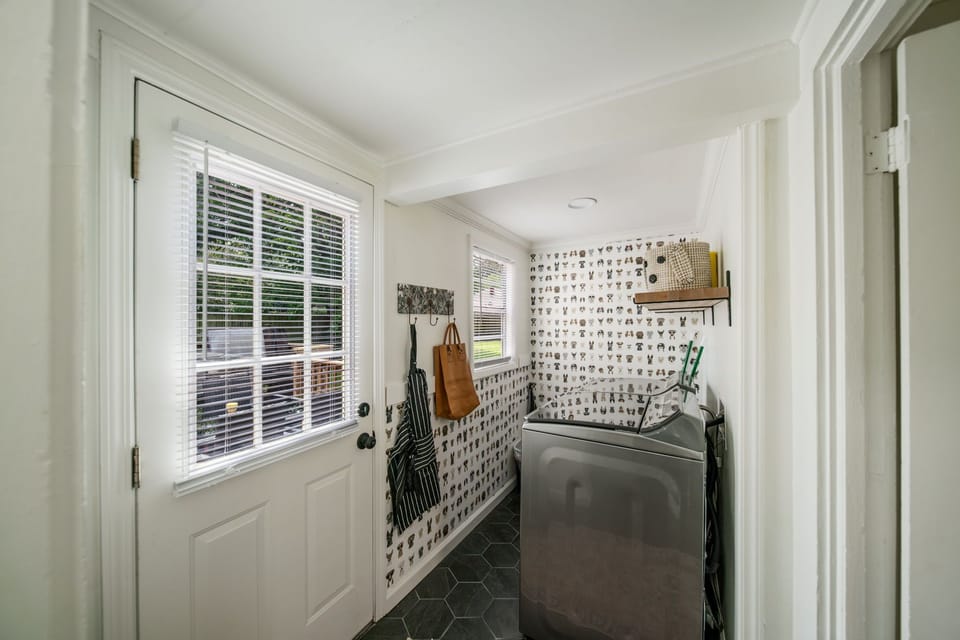 Fun dog wallpaper adorns the walls of the laundry room where you’ll find brand new state-of-the-art washer and dryer and lots of extra items you could need like hot tub towels, laundry soap and softener, stain remover, dog items, an apron, an umbrella, a leather tote bag for your use.  