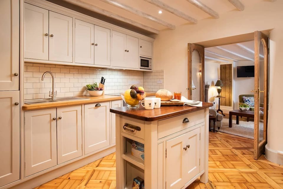 The Craftsman's Cottage - newly fitted kitchen with integrated appliances and access to the sitting room through the french doors