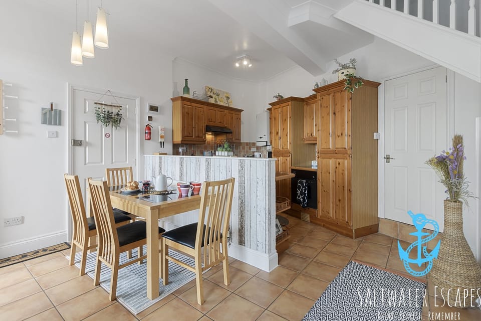 Fully equipped kitchen and dining area with table to seat 4 guests.