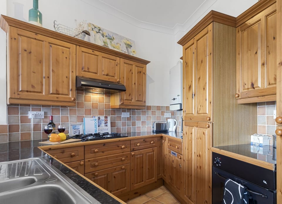 Fully equipped kitchen and dining area with table to seat 4 guests.