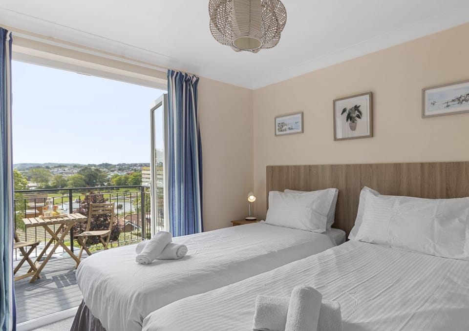 Twin bedroom with access to the decked sun terrace with stunning sea views.