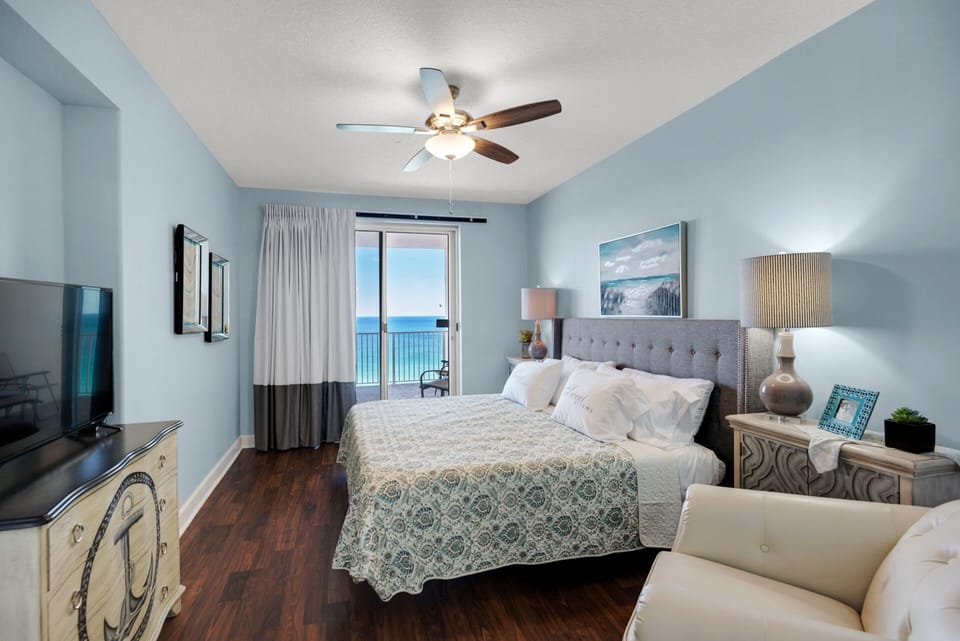 Master bedroom with a king size bed, flat screen TV and access to the private balcony!