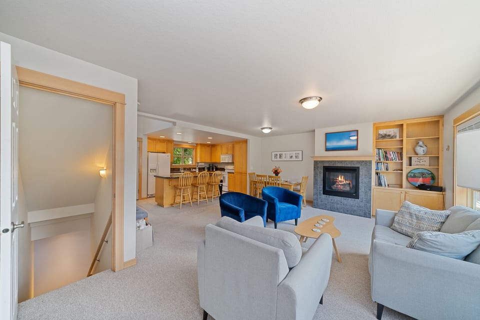 Living - Living area with books, games, gas fireplace, and access to upper deck area.