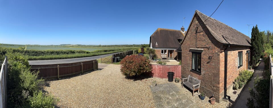Panoramic view of The Old Exchange, High Lea Cottage and the vale beyond