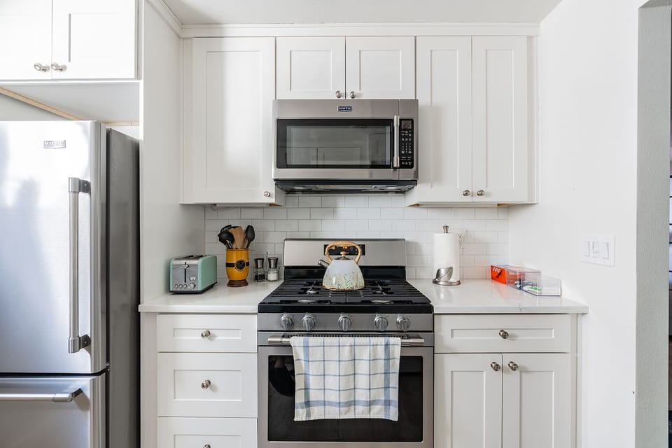 Full size kitchen with 5 burner gas stove and large size microwave 