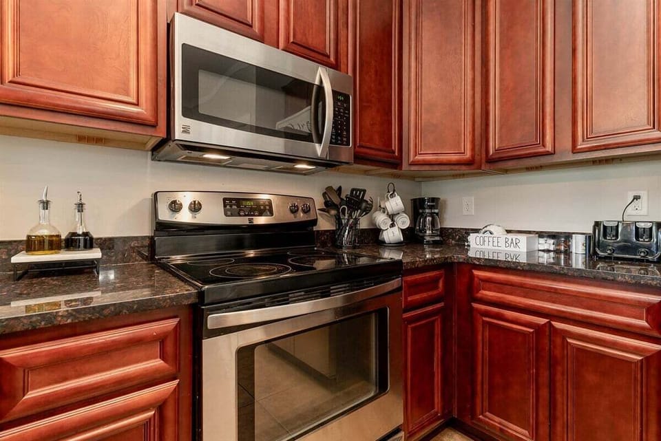 Prepare family meals with ease using the modern stainless steel stove and oven, complemented by a built-in microwave.