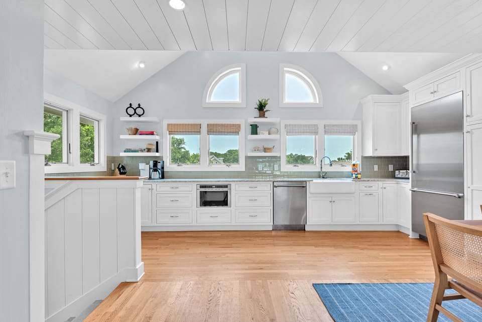 A fully stocked gourmet kitchen with loads of windows