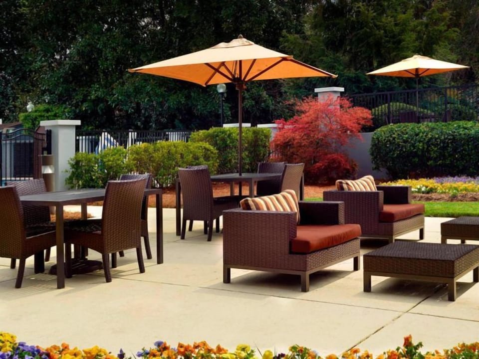 Relax under oversized umbrellas with cushioned seating and fresh air.