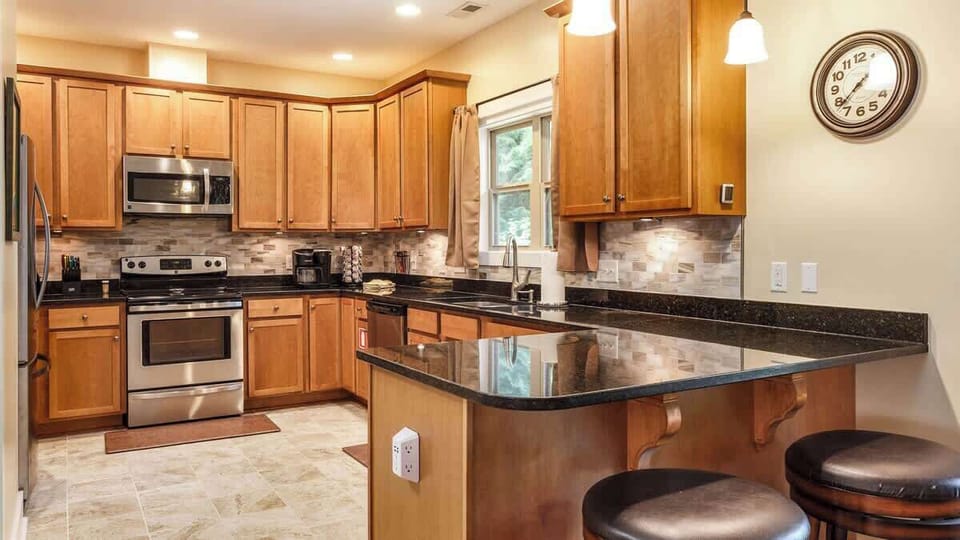 The roomy kitchen features granite countertops and stainless steel appliances and, as you can see, is not short on cabinet space.