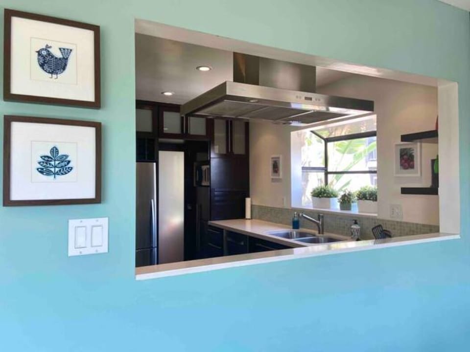 Open wall into the kitchen from dining area for easy serving and conversation.