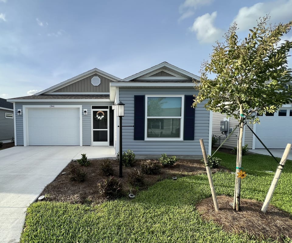 1 Car garage with golf cart garage.  Side patio with grill. Privacy wall 