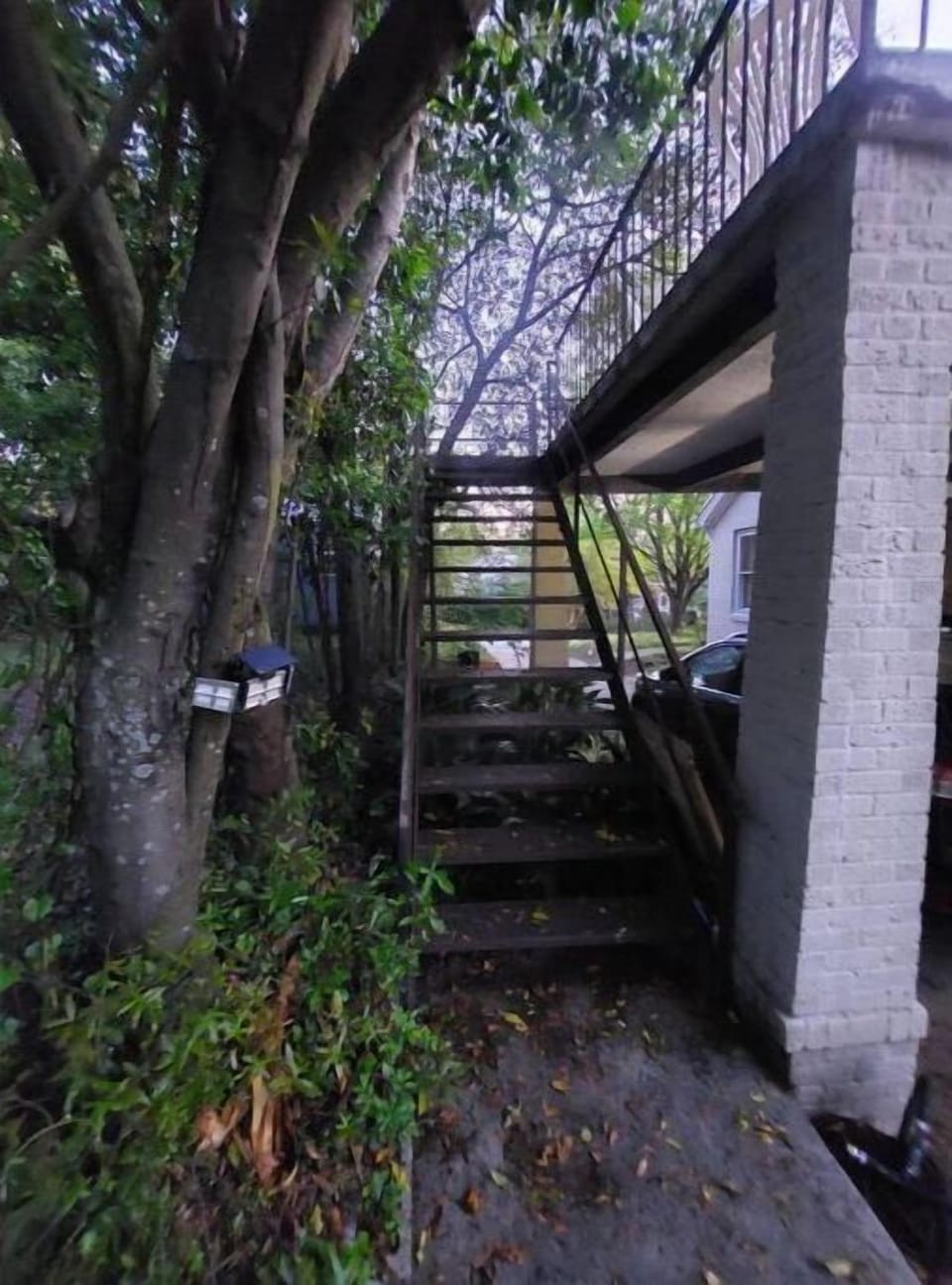 Well-lit stairway to patio & entrance