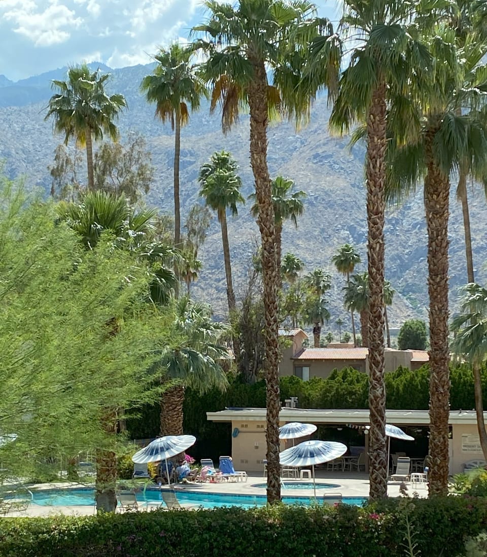 View of mountains and pool from guest room balcony