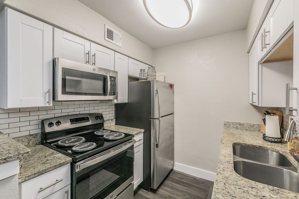 Modern kitchen w/ stainless steel appliances ideal for foodies and entertainers