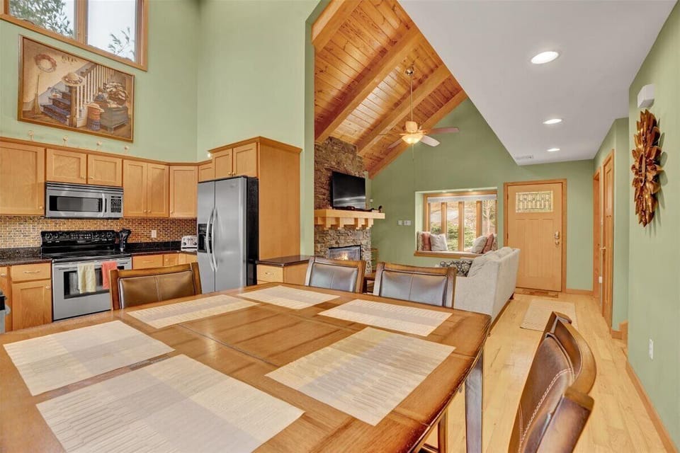 Dining area with kitchen, living room view. and wooden touch.