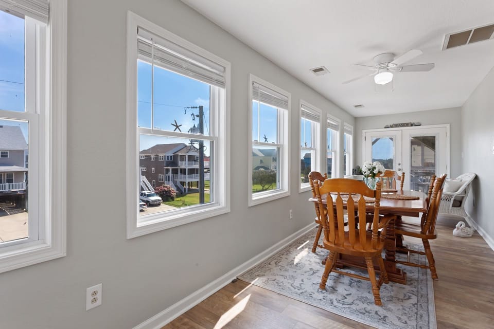 Relax in the Sun Room to soak up the sunshine and Outer Banks warmth.