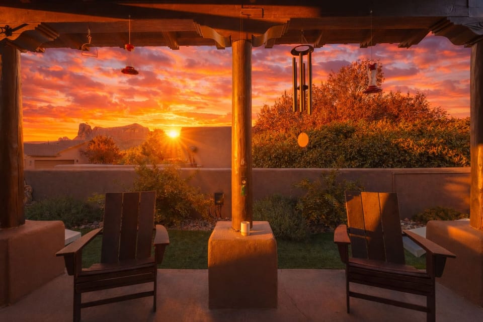 Covered patio with Adirondack chairs and stunning sunset mountain views
