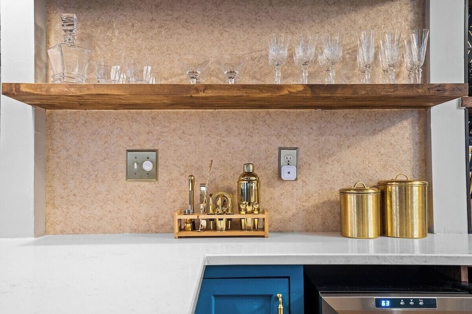 Enjoy a beautifully curated kitchen with ample counter space, sleek finishes, and a full suite of cookware—ideal for guests who love to cook while staying in walkable Midtown KC.