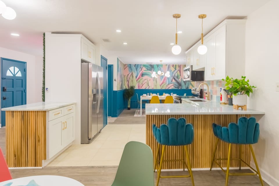 Open concept kitchen with all the utensils, pots, pans, blender, rice maker, toaster, etc you would expect to be able to cook a great meal for your family and friends! 2 dining rooms and bar-top seating can accommodate your entire group!