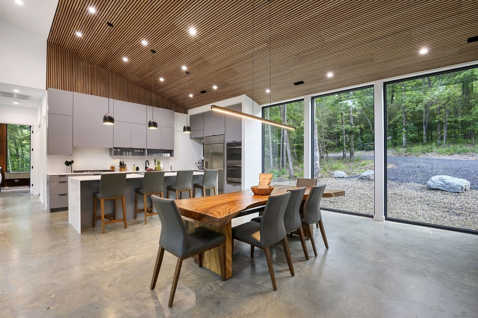 Dining Room: Gather around a stunning walnut table with nature as your backdrop!