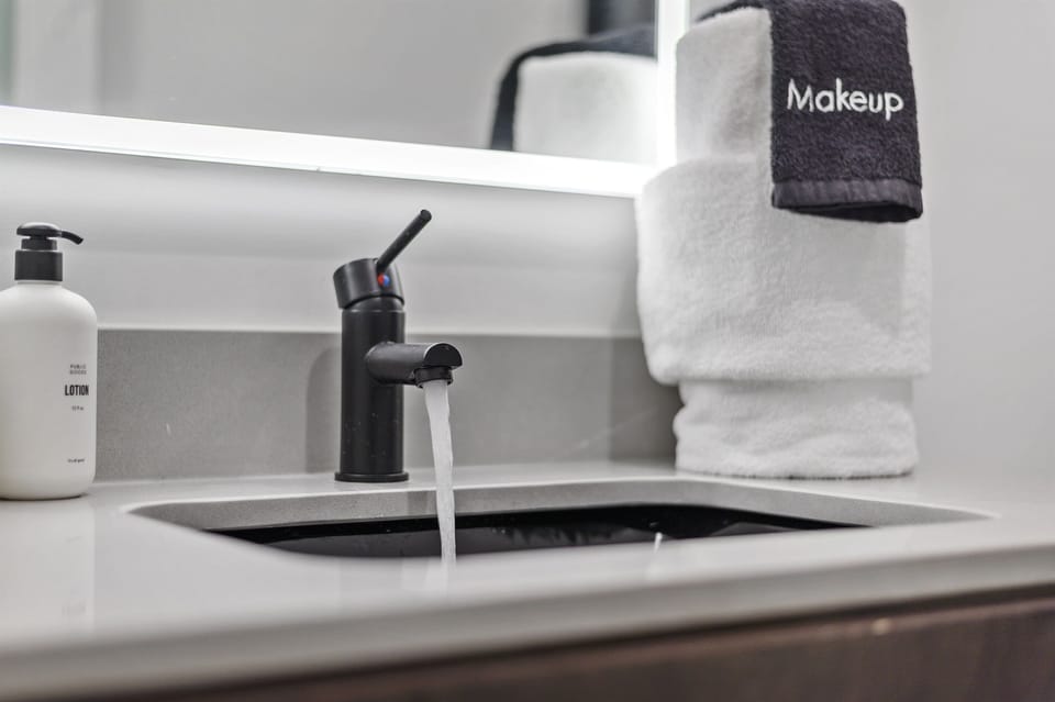 Modern Bathroom: Sleek black fixtures and plush towels offer a touch of elegance for your retreat!