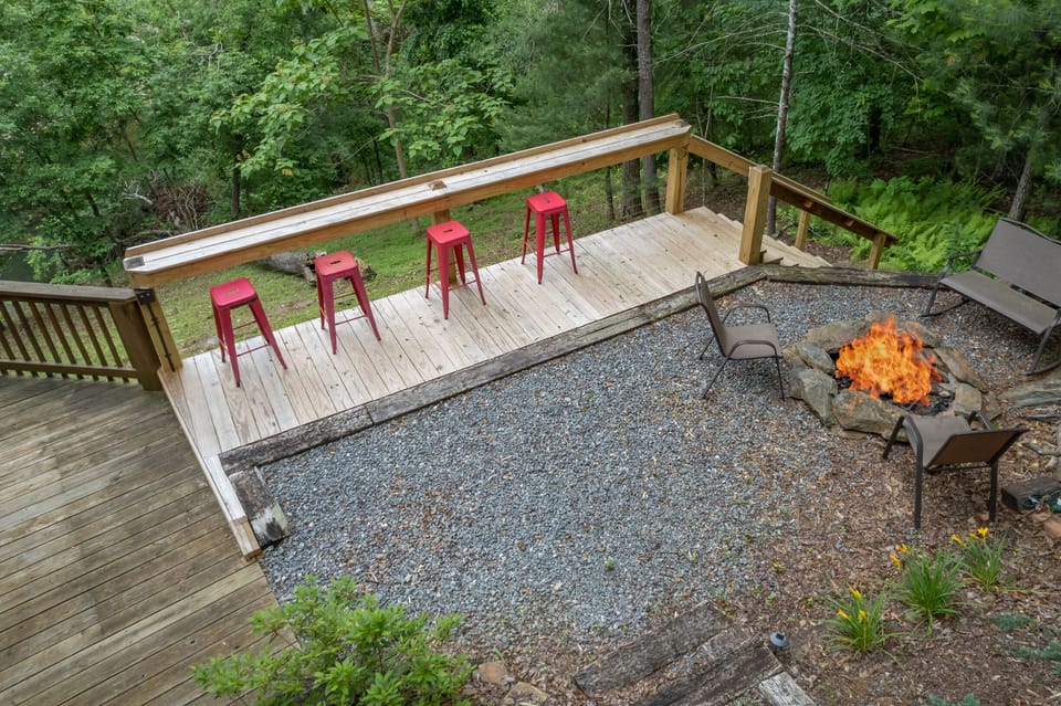 Firepit area with deck and seating overlooking the river