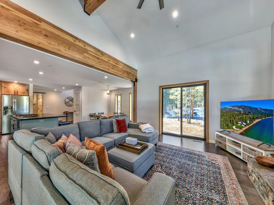 Living room with large sofa, open living to kitchen