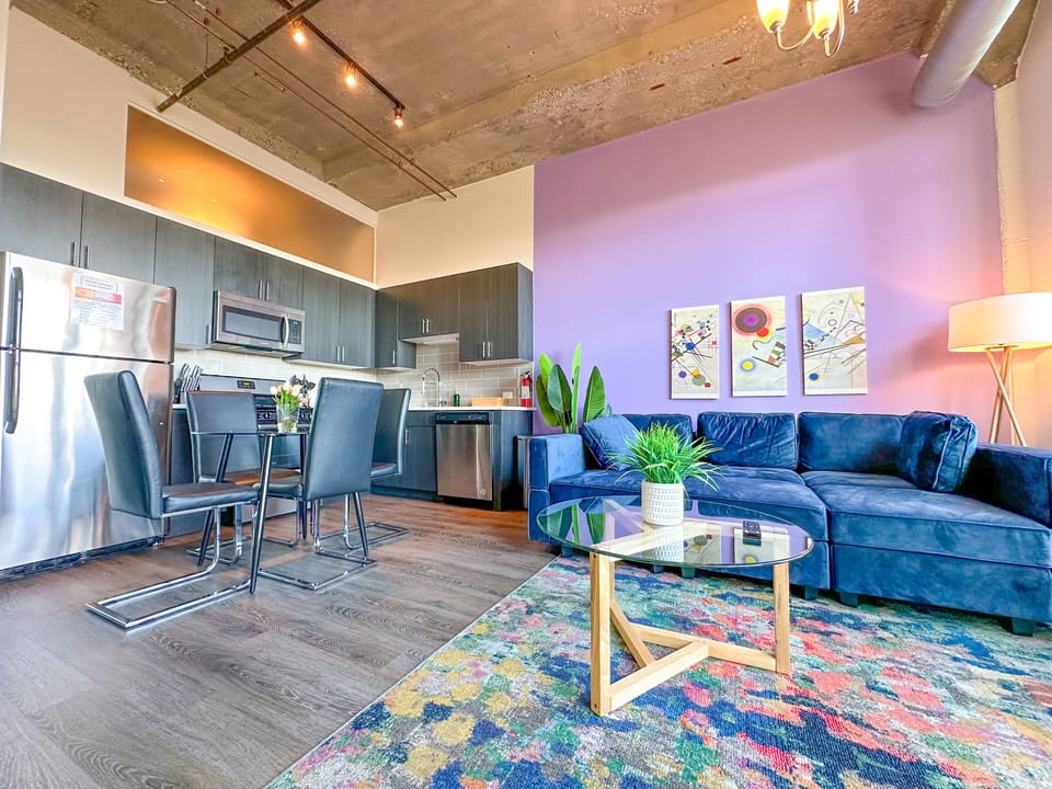 Spacious living room with a lot of natural light and large windows.