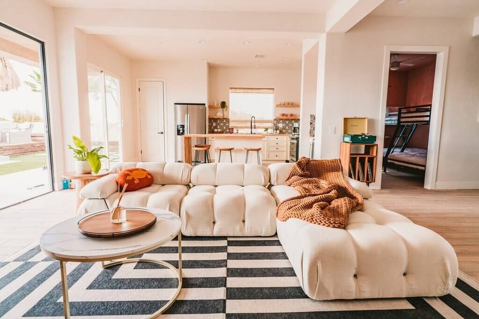 Living room with 80" Samsung Frame TV, gas fireplace and folding door system - walk out to the backyard.