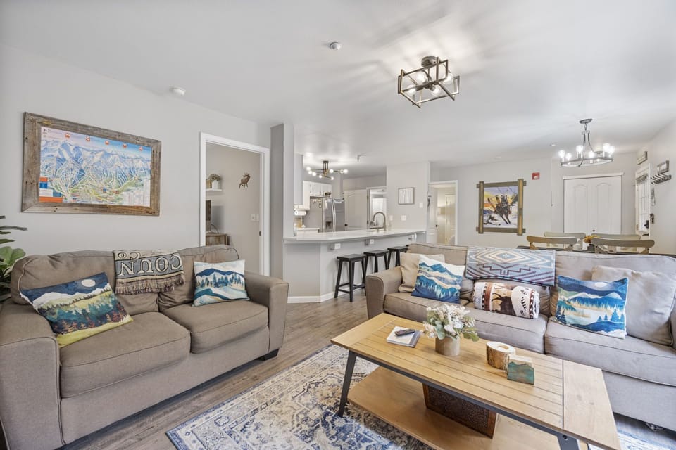 Living room area with ample seating, sleeper sofa, gas fireplace, large Roku tv